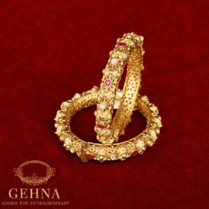 Golden bangles with red and white stones
