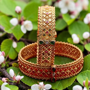 Antique gold designer bangle with red and green stones